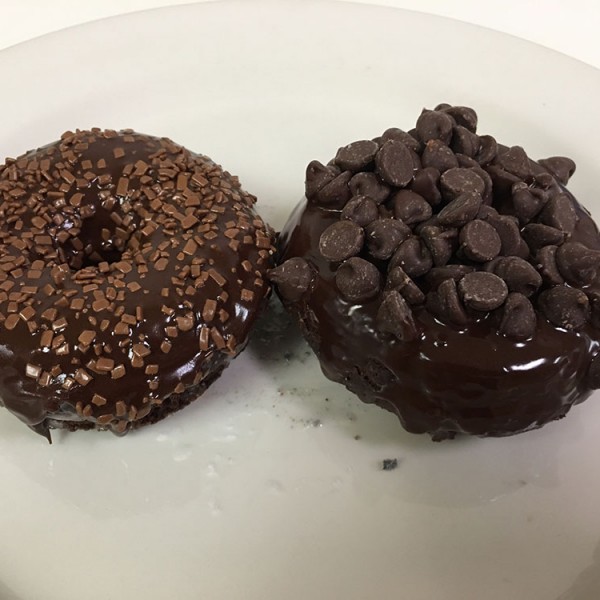 Death-by-Chocolate-donut.-It-is-a-chocolate-cake-donut-that-is-glazed,-topped-with-chocolate-frosting-and-topped-with-chocolate-chips-or-chocolate-sprinkles
