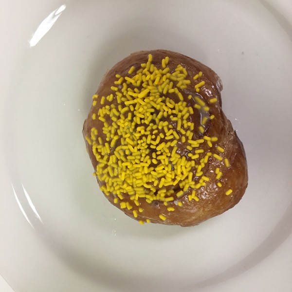 Roll-in-the-Hay-donut.-It-is-a-glazed-cinnamon-roll-with-sprinkles